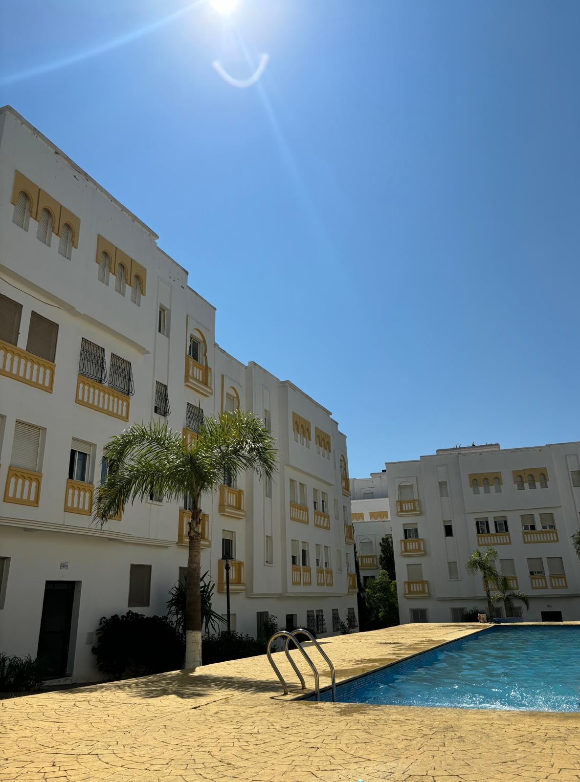 Pool area surrounded by palm trees in Dar Salma Tangier